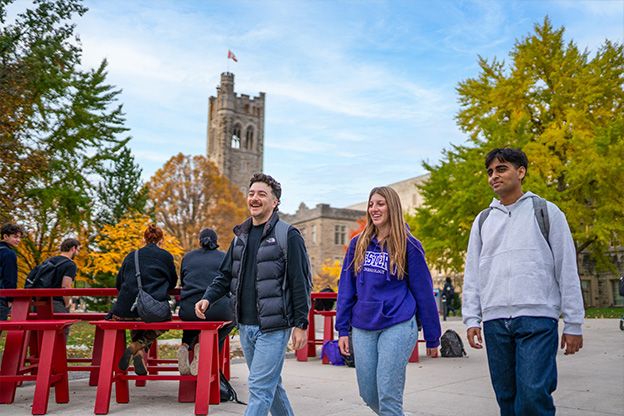 Three students walking across Western University
