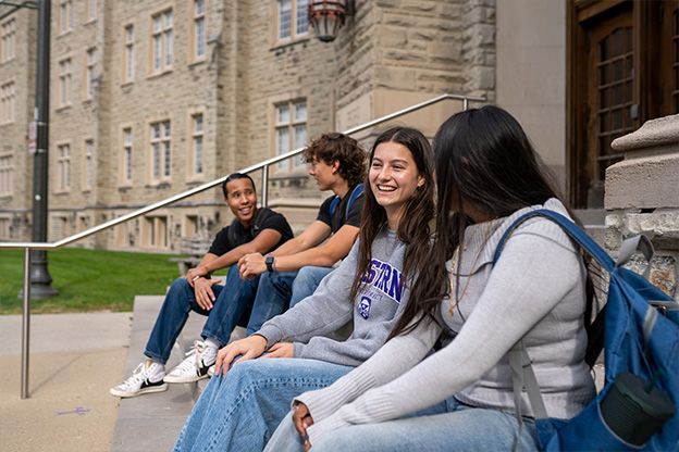 A group of students smiling at each other