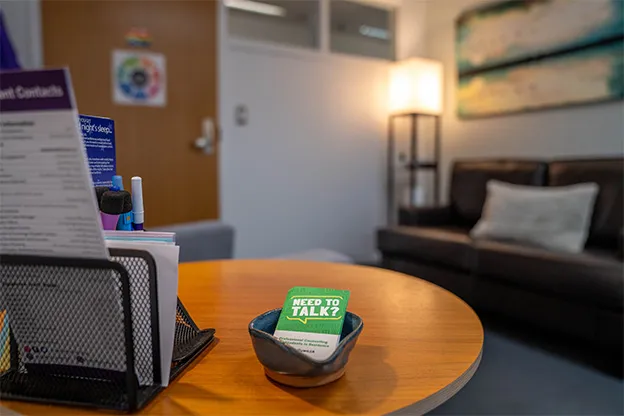 Photo of a desk with a card that reads "Need to talk?"